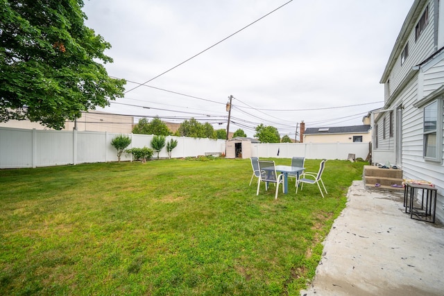 47 Cardinal Rd, Levittown, NY 11756 - fenced backyard featuring a storage unit and a patio area