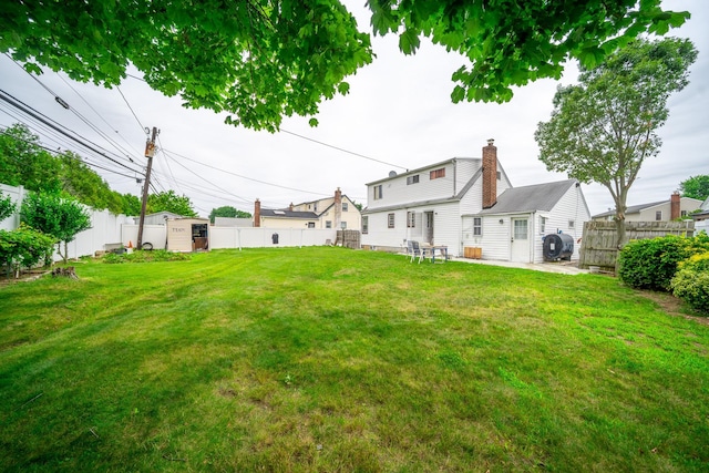 47 Cardinal Rd, Levittown, NY 11756 - fenced backyard featuring a storage unit