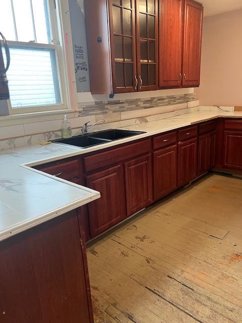 47 Gifford Ave, Poughkeepsie, NY 12601 - kitchen featuring light countertops, glass insert cabinets, and light wood finished floors