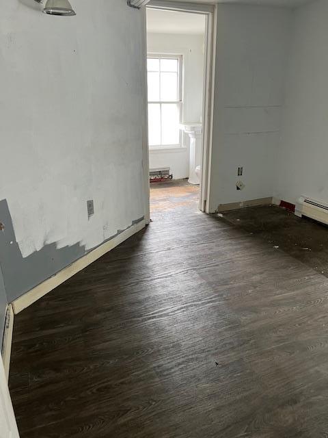 47 Gifford Ave, Poughkeepsie, NY 12601 - unfurnished room with dark wood-type flooring and a baseboard heating unit