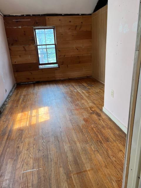 47 Gifford Ave, Poughkeepsie, NY 12601 - spare room with wood finished floors, wooden walls, and vaulted ceiling