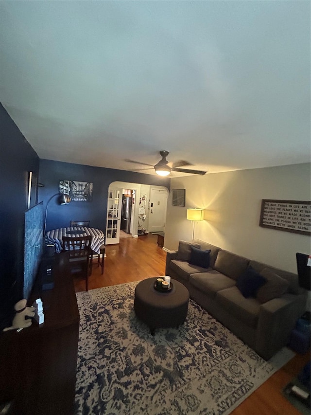 21543 48th Ave Unit 1E, Bayside, NY 11364 - living room featuring wood finished floors, a ceiling fan, and arched walkways