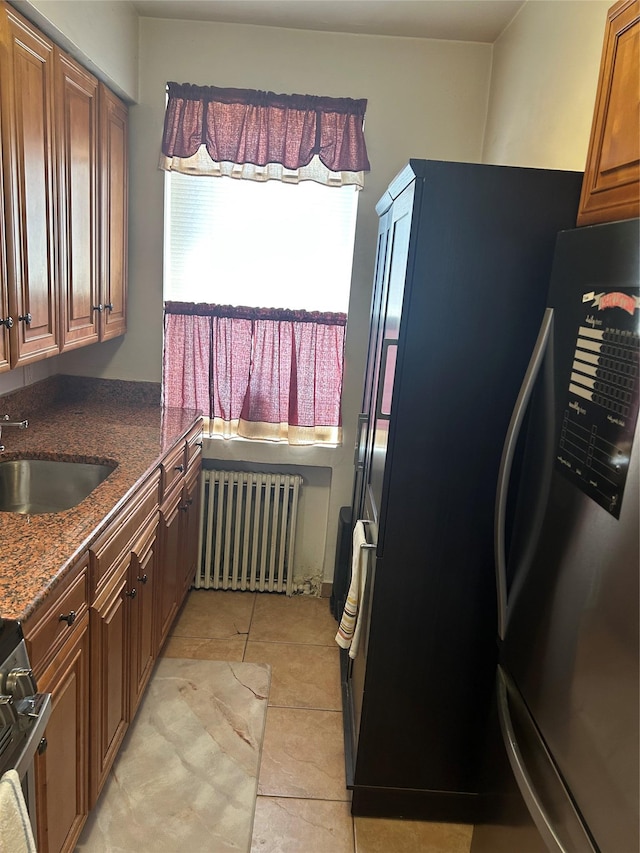 21543 48th Ave Unit 1E, Bayside, NY 11364 - kitchen featuring radiator heating unit, freestanding refrigerator, stove, and dark stone counters