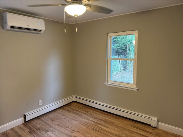22 Bradish Ln, Babylon, NY 11702 - unfurnished room with a wall unit AC, wood finished floors, a ceiling fan, crown molding, and a baseboard heating unit