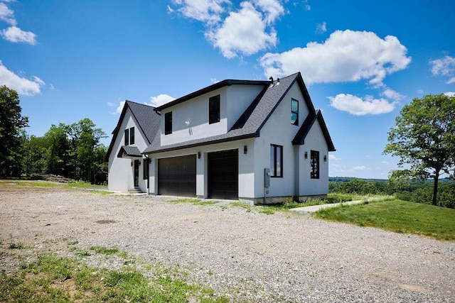 75 Red Fox Ln, Salt Point, NY 12578 - view of front facade featuring a garage, roof with shingles, stucco siding, and gravel driveway