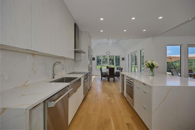 75 Red Fox Ln, Salt Point, NY 12578 - kitchen featuring modern cabinets, high quality appliances, wall chimney exhaust hood, light wood-style floors, and lofted ceiling