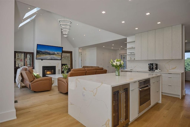75 Red Fox Ln, Salt Point, NY 12578 - kitchen with modern cabinets, wine cooler, stainless steel oven, open shelves, and recessed lighting