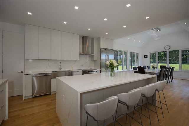 75 Red Fox Ln, Salt Point, NY 12578 - kitchen with appliances with stainless steel finishes, wall chimney exhaust hood, modern cabinets, light wood finished floors, and lofted ceiling
