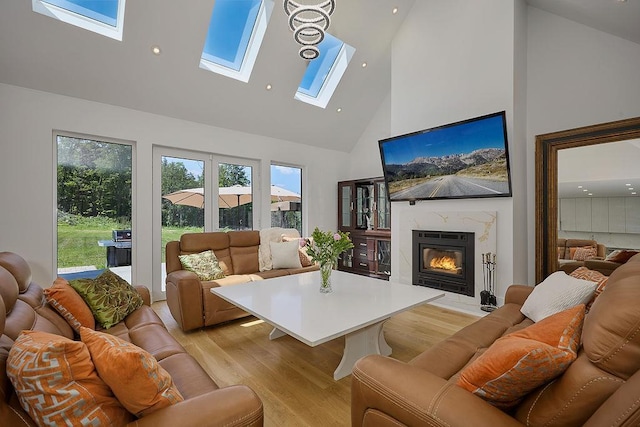 75 Red Fox Ln, Salt Point, NY 12578 - living area with high vaulted ceiling, a skylight, light wood-style floors, a glass covered fireplace, and recessed lighting