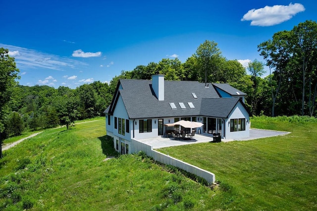75 Red Fox Ln, Salt Point, NY 12578 - back of property with a patio area, a chimney, a lawn, and a wooded view