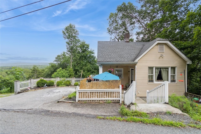 126 Tanglewylde Rd, Lake Peekskill, NY 10537 - view of front of property featuring a chimney and a shingled roof