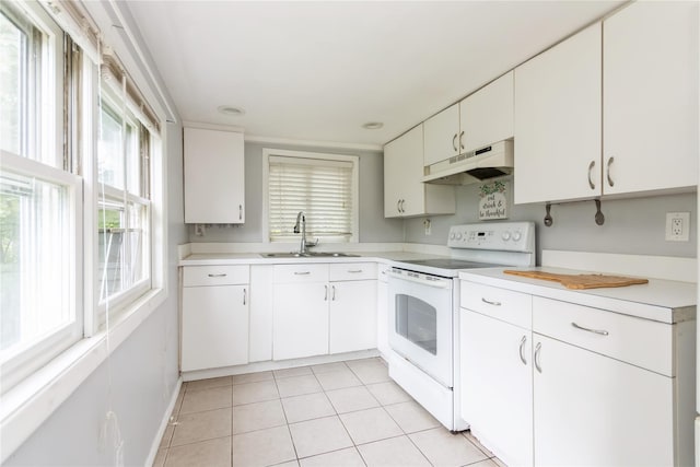 126 Tanglewylde Rd, Lake Peekskill, NY 10537 - kitchen with white electric stove, under cabinet range hood, light countertops, and light tile patterned floors