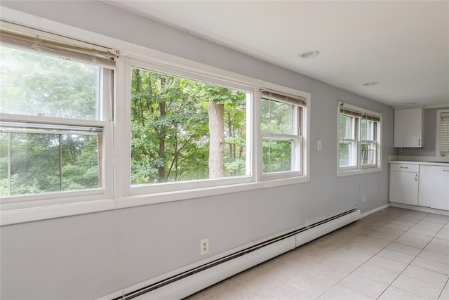 126 Tanglewylde Rd, Lake Peekskill, NY 10537 - unfurnished dining area with a baseboard heating unit and light tile patterned floors