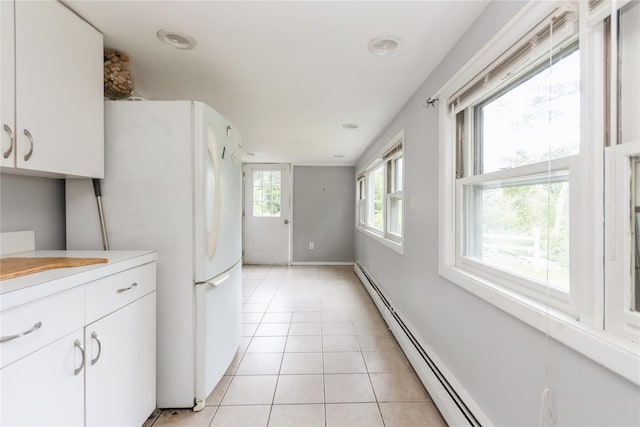 126 Tanglewylde Rd, Lake Peekskill, NY 10537 - kitchen featuring freestanding refrigerator, light countertops, light tile patterned flooring, white cabinetry, and recessed lighting