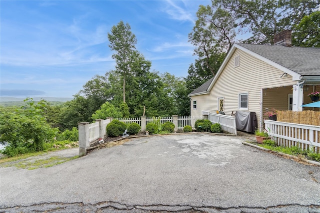 126 Tanglewylde Rd, Lake Peekskill, NY 10537 - view of side of home featuring a chimney and a shingled roof