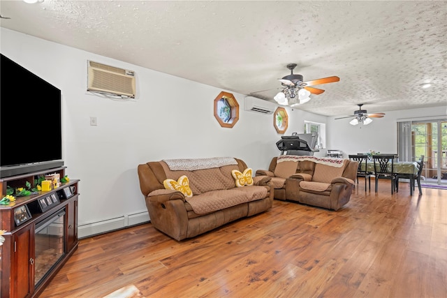 578 S St, Plattekill, NY 12528 - living area featuring baseboard heating, a textured ceiling, light wood-style flooring, a wall mounted AC, and a wall unit AC