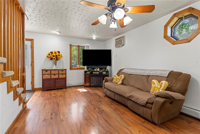 578 S St, Plattekill, NY 12528 - living room featuring a baseboard heating unit, ceiling fan, a wall unit AC, and wood finished floors