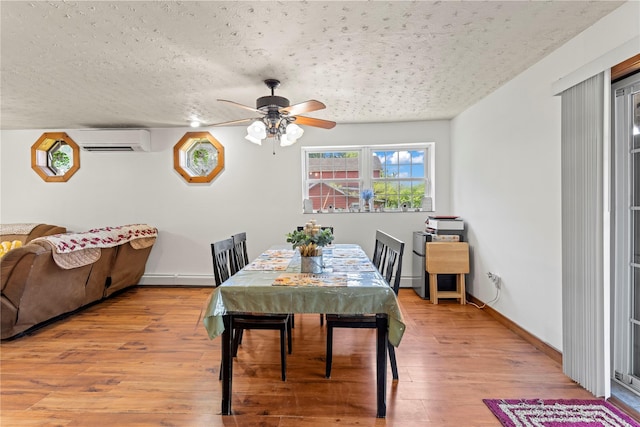578 S St, Plattekill, NY 12528 - dining space featuring an AC wall unit, a baseboard radiator, a textured ceiling, a ceiling fan, and wood finished floors