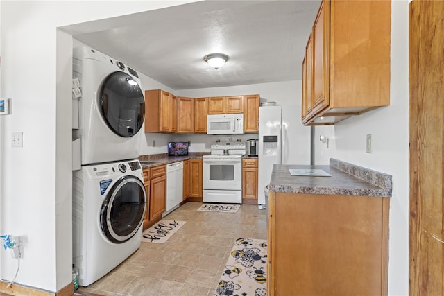 578 S St, Plattekill, NY 12528 - kitchen with white appliances, stacked washing machine and dryer, dark countertops, and brown cabinetry