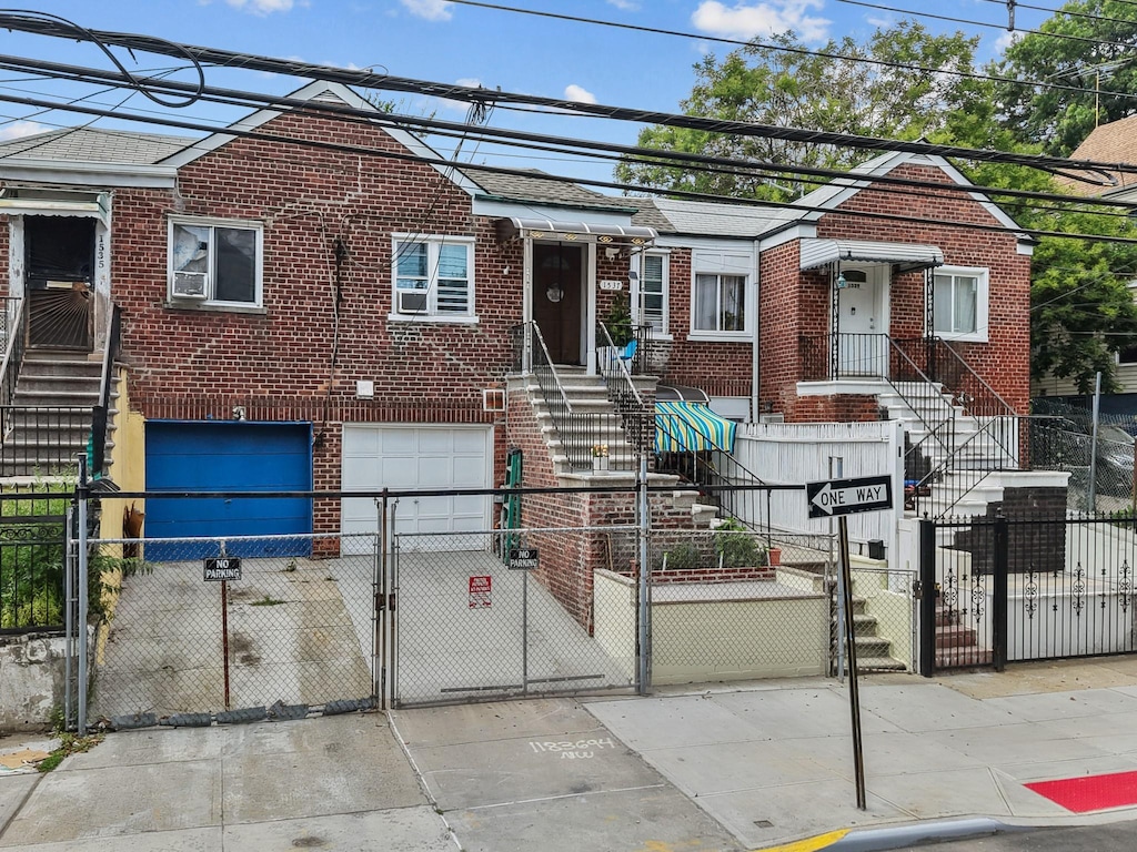 1537 Beach Ave, Bronx, NY 10460 - view of front of house with brick siding, a gate, an attached garage, and a fenced front yard