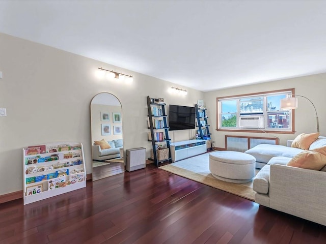 29-49 137th St Unit 6G, Flushing, NY 11354 - living area featuring radiator heating unit, wood finished floors, and rail lighting