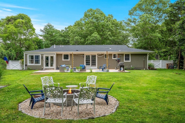 24 Canvasback Ln, East Quogue, NY 11942 - back of house with a gate, french doors, a patio, a fenced backyard, and an outdoor living space with a fire pit