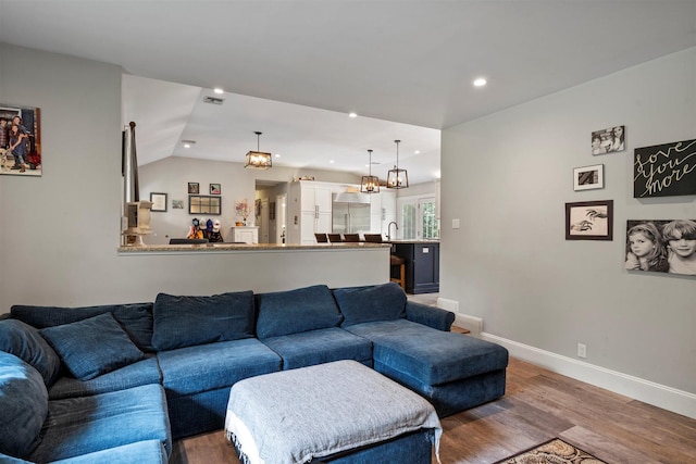 24 Canvasback Ln, East Quogue, NY 11942 - living area featuring wood finished floors, recessed lighting, and vaulted ceiling