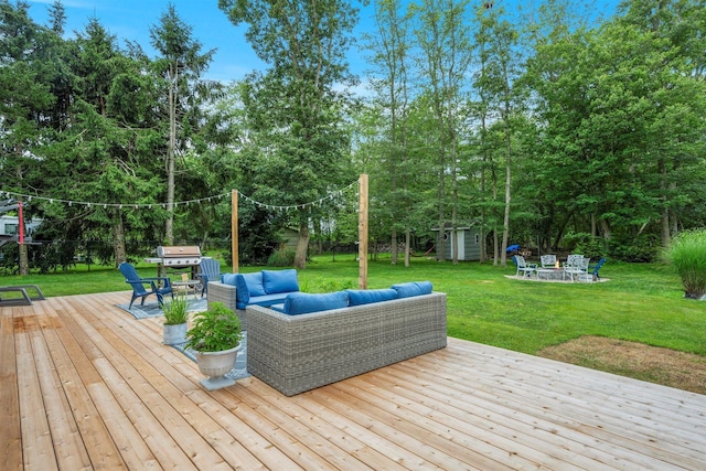 24 Canvasback Ln, East Quogue, NY 11942 - deck with an outdoor living space, a storage unit, a lawn, and view of scattered trees
