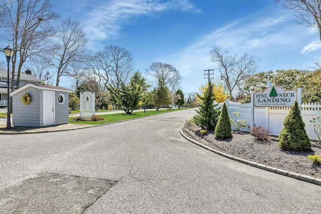 24 Canvasback Ln, East Quogue, NY 11942 - view of asphalt street with curbs and street lights