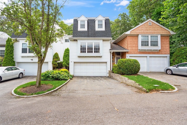 28 The Mews, Syosset, NY 11791 - view of front facade with a shingled roof, a garage, and asphalt driveway