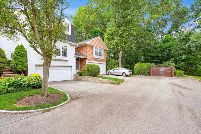 28 The Mews, Syosset, NY 11791 - view of front of property with driveway, a garage, and roof with shingles