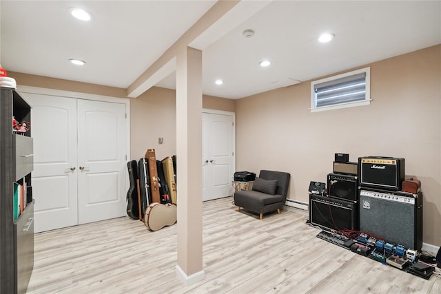 28 The Mews, Syosset, NY 11791 - finished below grade area with light wood-style flooring, recessed lighting, and baseboard heating