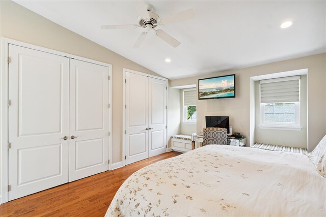 28 The Mews, Syosset, NY 11791 - bedroom with multiple closets, vaulted ceiling, light wood-type flooring, recessed lighting, and a ceiling fan