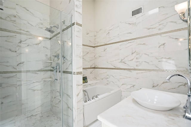 28 The Mews, Syosset, NY 11791 - bathroom featuring a bath, a marble finish shower, tile walls, and vanity