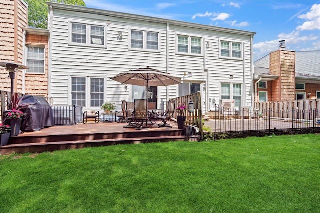 28 The Mews, Syosset, NY 11791 - rear view of house featuring a wooden deck and outdoor dining space