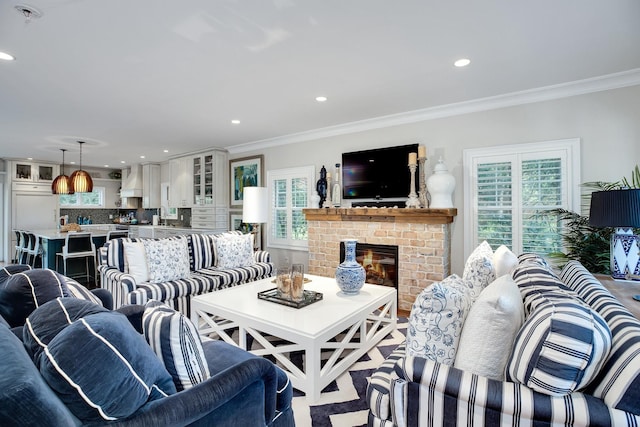 3120 Grathwohl Rd, New Suffolk, NY 11956 - living room with plenty of natural light, crown molding, recessed lighting, and a fireplace
