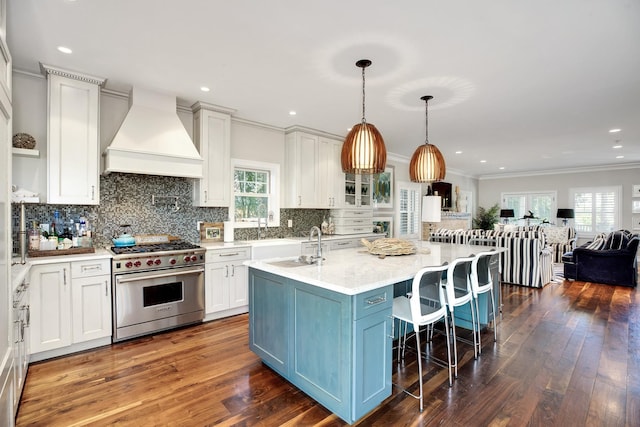 3120 Grathwohl Rd, New Suffolk, NY 11956 - kitchen featuring luxury stove, custom range hood, open floor plan, ornamental molding, and white cabinetry