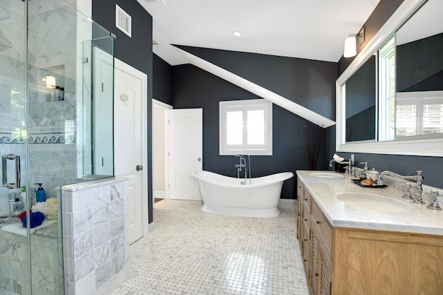 3120 Grathwohl Rd, New Suffolk, NY 11956 - bathroom featuring a shower stall, double vanity, a freestanding tub, and lofted ceiling