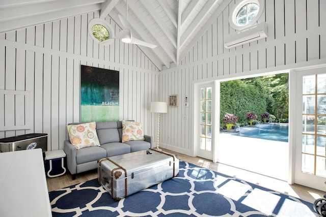 3120 Grathwohl Rd, New Suffolk, NY 11956 - living area with high vaulted ceiling, an AC wall unit, wood finished floors, plenty of natural light, and beamed ceiling
