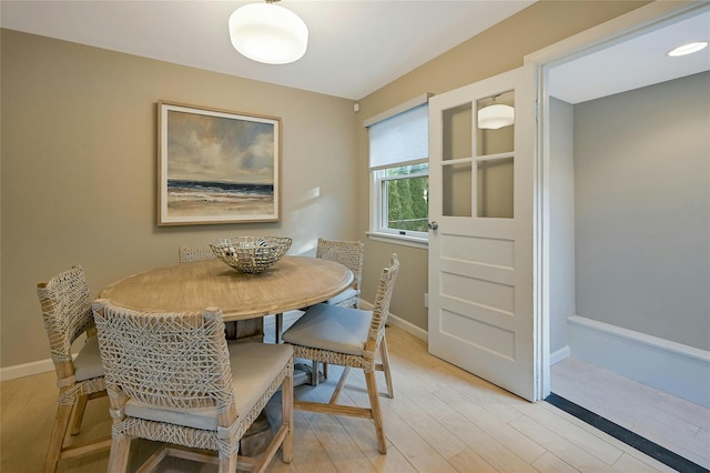 3120 Grathwohl Rd, New Suffolk, NY 11956 - dining space featuring light wood-style flooring and baseboards