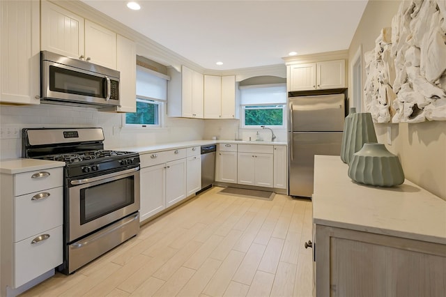 3120 Grathwohl Rd, New Suffolk, NY 11956 - kitchen with appliances with stainless steel finishes, healthy amount of natural light, light countertops, backsplash, and recessed lighting