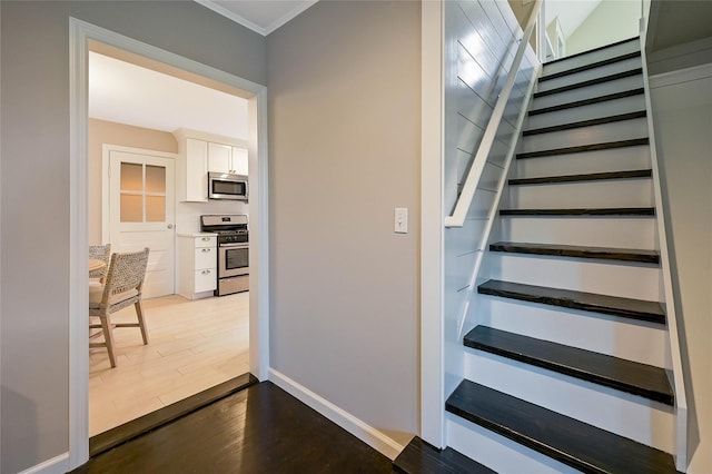 3120 Grathwohl Rd, New Suffolk, NY 11956 - stairway featuring wood finished floors and crown molding