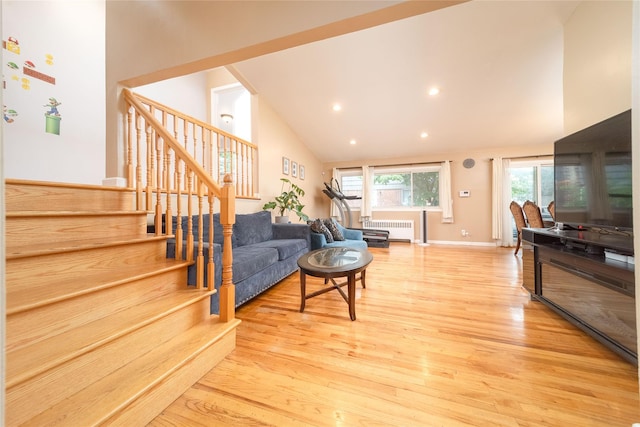 98 Virginia Ave, Plainview, NY 11803 - living area with radiator, stairway, high vaulted ceiling, wood finished floors, and recessed lighting
