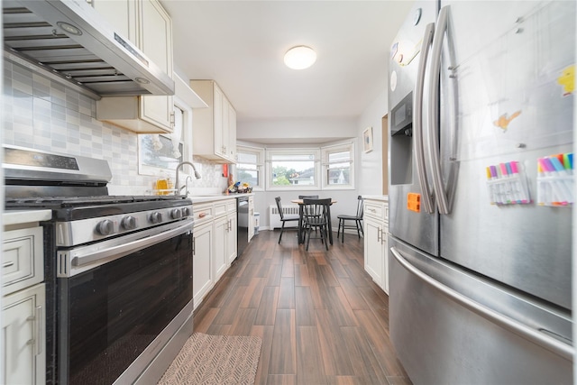 98 Virginia Ave, Plainview, NY 11803 - kitchen with appliances with stainless steel finishes, extractor fan, light countertops, and backsplash