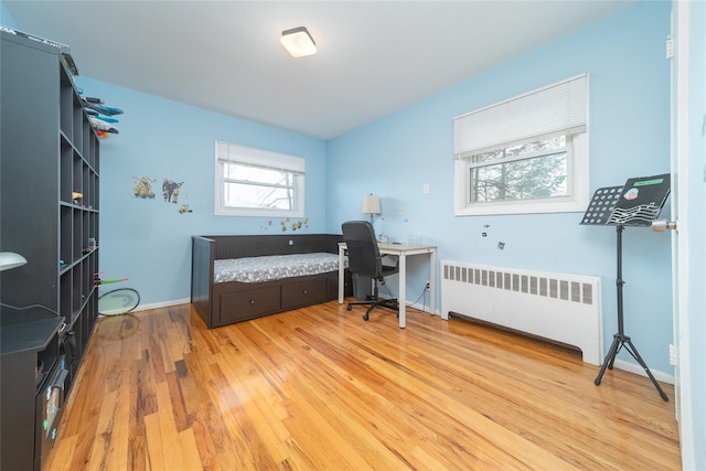 98 Virginia Ave, Plainview, NY 11803 - office area featuring radiator heating unit and light wood-type flooring