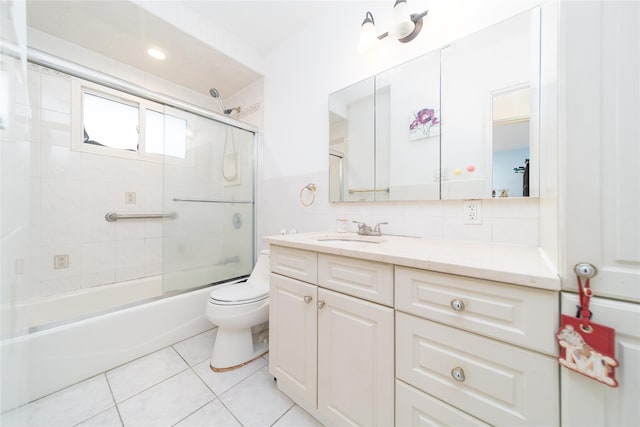 98 Virginia Ave, Plainview, NY 11803 - bathroom featuring vanity, bath / shower combo with glass door, tile patterned floors, and tile walls