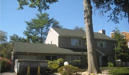 1554 Hewlett Heath Rd, Hewlett, NY 11557 - view of front facade featuring a garage