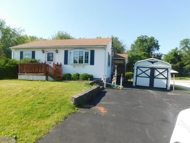967 State Route 17k, Montgomery, NY 12549 - view of front of house featuring a front lawn, a wooden deck, a storage shed, and driveway