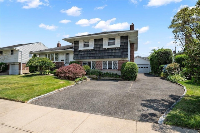 20 Deb St, Plainview, NY 11803 - split level home with a chimney, brick siding, a front yard, and an outbuilding