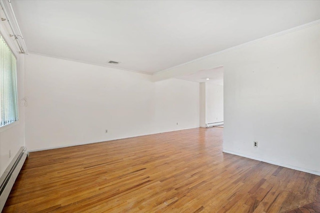 20 Deb St, Plainview, NY 11803 - empty room featuring baseboard heating, light wood-type flooring, crown molding, and a baseboard radiator